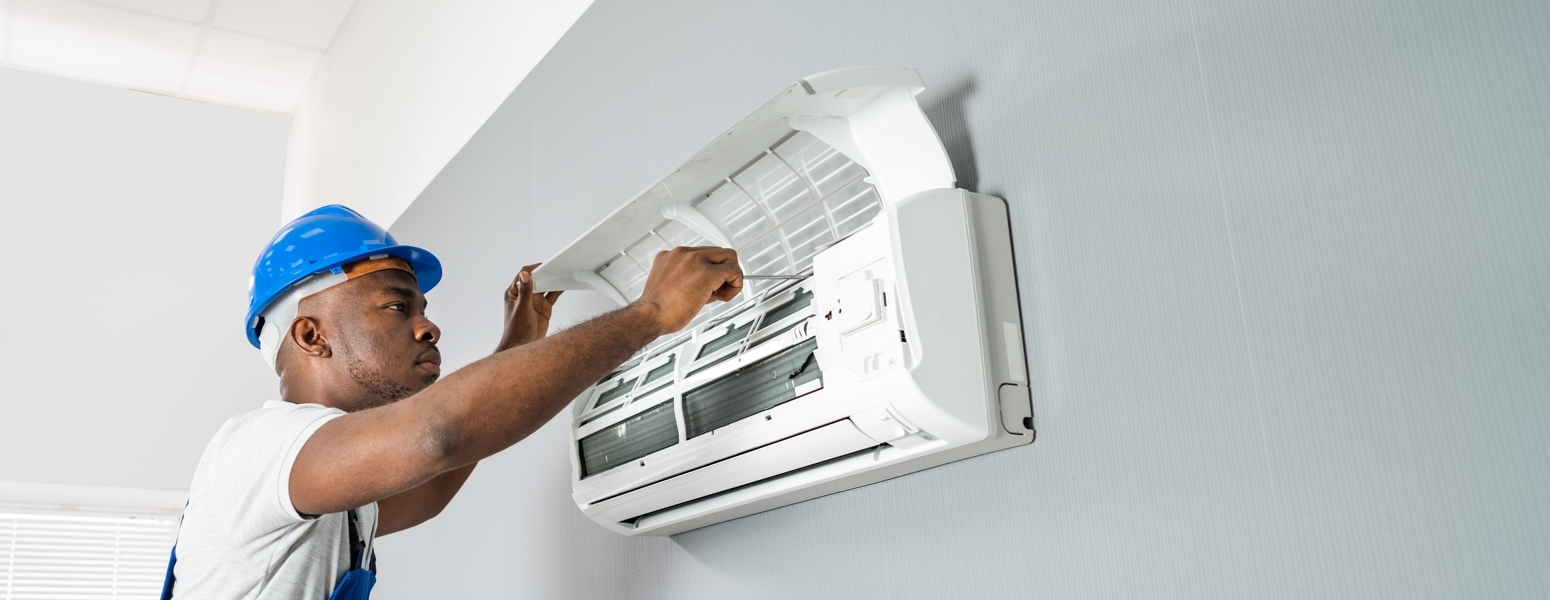 HVAC technician repairing an AC